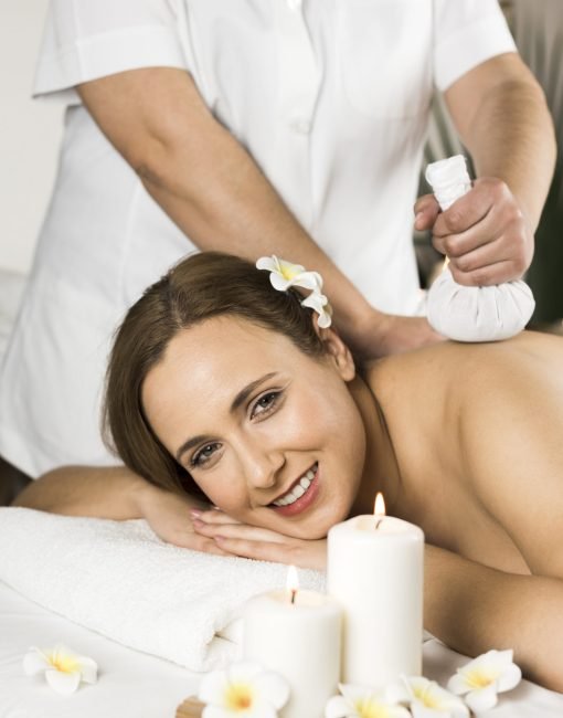 woman-receiving-massage-spa-center
